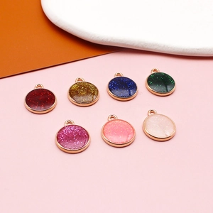 Macro view of colorful glitter round alloy charms in seven vibrant pearlescent finishes