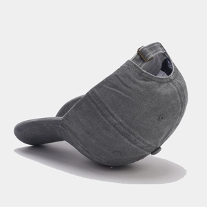 Detail of adjustable metal buckle and cotton texture on gray washed baseball cap