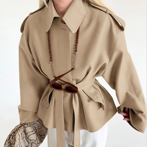 Classic khaki short trench coat with wide lapels and waist belt for a stylish women's look