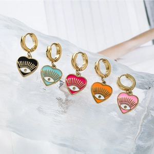 Five pairs of heart-shaped evil eye drop earrings in multiple vibrant colors on a clear stand