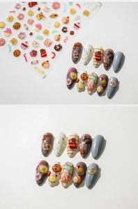 Detail view of dessert-themed nail stickers with 3D donuts and cakes on color tips