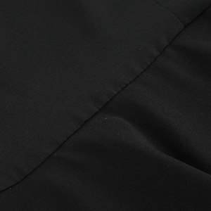 Macro shot of precise stitching and premium black fabric texture on the ruffle dress