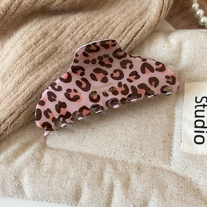 Close-up of pink leopard acetate hair claw clip with golden Barrette la France script