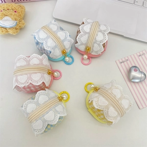 Close-up of cute floral fabric earphone pouches with lace trim and pearl zipper charms