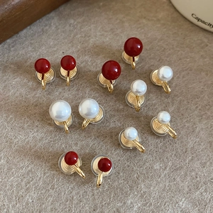Detailed view of pearl clip-on earrings with gold metal and silicone pads for comfort
