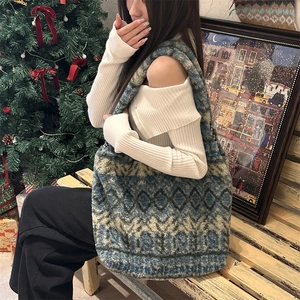 Detailed plush tote bag with geometric diamond patterns in a cozy winter setting