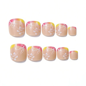 Detail of square press-on toenails with gradient tips and white floral patterns