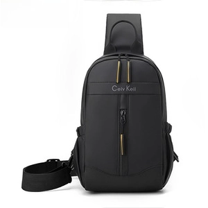 Detail of black crossbody bag with yellow zipper pulls and Celv Keil logo text