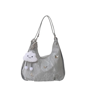 Chic gray hobo tote bag with metal butterfly details and cloud pendant on white background