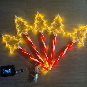 Outdoor solar LED Christmas tree stake lights with red striped candy cane poles for garden decoration