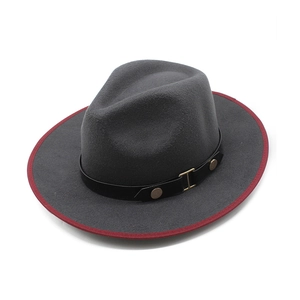 Detail of dark grey wool fedora featuring red bound edge and black leather band with studs