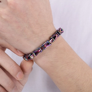 Close-up of rainbow Byzantine chain bracelet on wrist showing vibrant metallic gradient