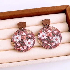 Retro round floral print wooden earrings on beige velvet tray with elegant design