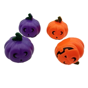 Set of four orange and purple Halloween plastic pumpkins for festive table decorations