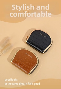 Top-down view of black and brown crocodile textured PU leather wallets with gold zippers