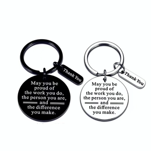 Detailed view of engraved stainless steel keychains in black and silver finishes