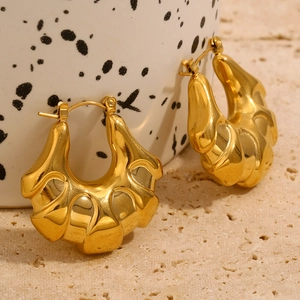 Macro shot of 18K gold plated hollow hoop earrings with chunky horn texture on stone