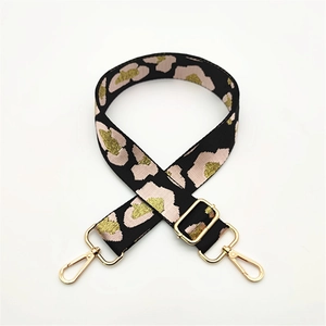 Close-up of pink leopard print wide strap with gold-tone hardware and buckle