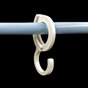 White S-shaped clip hook for wardrobe and kitchen bars on dark background