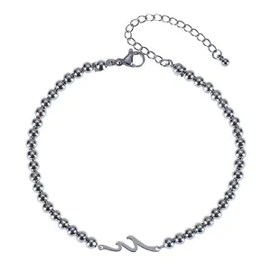 Detail view of silver wave bracelet with polished metal beads and lobster clasp closure