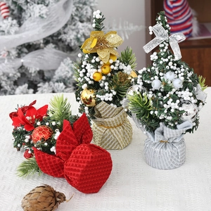 Three mini Christmas tabletop trees in red, gold, and silver with festive ornaments