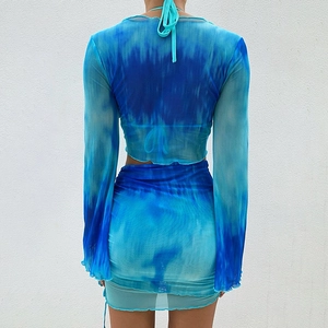 Women's blue tie-dye mesh set featuring a long sleeve V-neck top and mini skirt