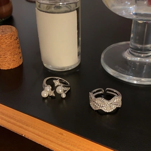 Detailansicht von zwei minimalistischen silbernen verstellbaren Ringen mit Perlen und Zirkonia
