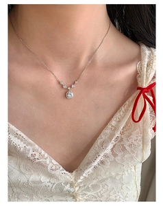 Close-up of a square zircon pendant necklace on model with silver chain and stones