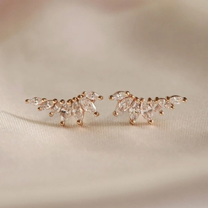 Luxurious wing-shaped gold earrings with marquise-cut zircons for an elegant look