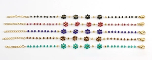 Detail of five gold chain bracelets with colorful crystal flower charms and lobster clasps
