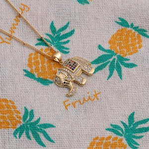 Golden elephant pendant necklace with colorful gems and sparkling cubic zirconia on bead chain
