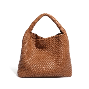 Handwoven caramel leather tote bag with a minimalist design and spacious shoulder handle