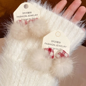 Detailed close-up of cream pom-pom earrings with red plaid bows on S925 silver needles