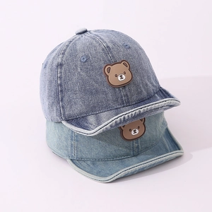 Detail of child denim baseball cap with 3D cartoon bear patch and soft brim