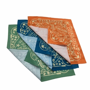 Detail of nautical print bandanas in orange, navy, and green with Yacht Club motifs