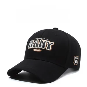 Detailed embroidery on a black cotton baseball cap showing fine stitching and texture