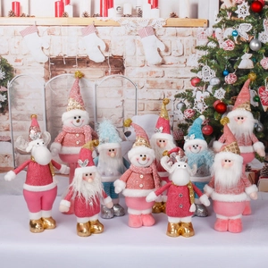 Standing plush Christmas figures featuring Santa and Reindeer in pink and gold tones