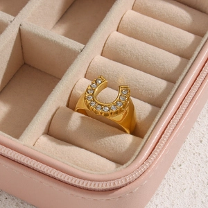 18K gold plated horseshoe ring with sparkling cubic zirconia on pink velvet box
