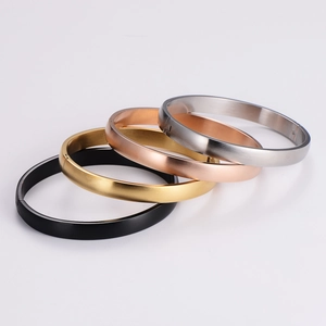 Minimalist matte metal bangles in black, gold, rose gold, and silver on white background