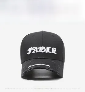 Detailed embroidery of white letters and distressed brim on vintage black baseball cap