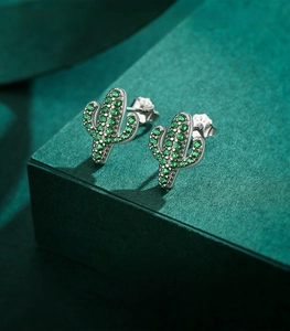 Macro shot of S925 sterling silver cactus stud earrings with green cubic zirconia