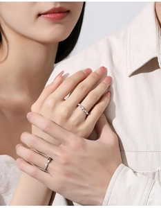 Close-up of S925 sterling silver couple rings with pavé zircon and geometric design