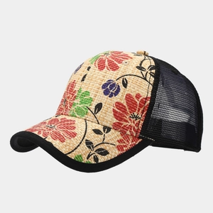 Close-up of floral print straw visor and black mesh on truckers hat for sun protection