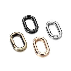 Detail view of oval spring rings in black nickel, gun black, bronze, and light gold