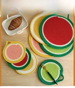 Close-up of fruit-themed cotton rope woven placemats on a cozy wooden table setting