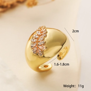 Detail view of gold geometric ring with zircon stones, showing size and weight specs