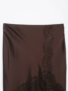 Detailed close-up of dark brown satin midi skirt featuring elegant lace patchwork edges