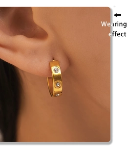 Wearing effect of C-shaped 18K gold plated earrings with three inset zircon stones