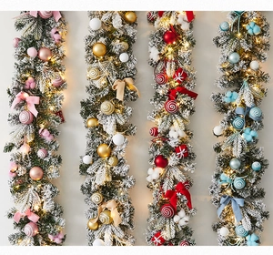 Detailed view of four lighted Christmas garlands in pink, gold, red, and blue colorways