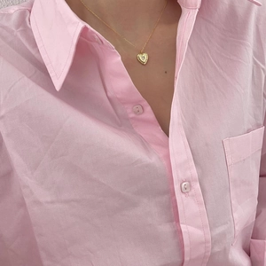 Minimalist golden heart pendant necklace with zircon stone on elegant model